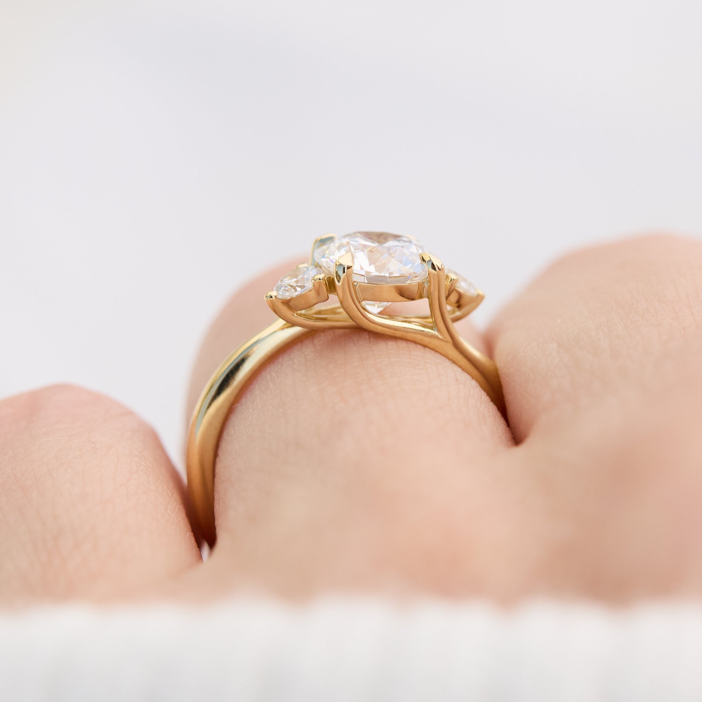 round brilliant cut trilogy diamond engagement ring set in yellow gold