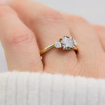 round salt and pepper diamond trilogy engagement ring in yellow gold