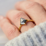 yellow gold solitaire ring with a kite shape salt and pepper diamond