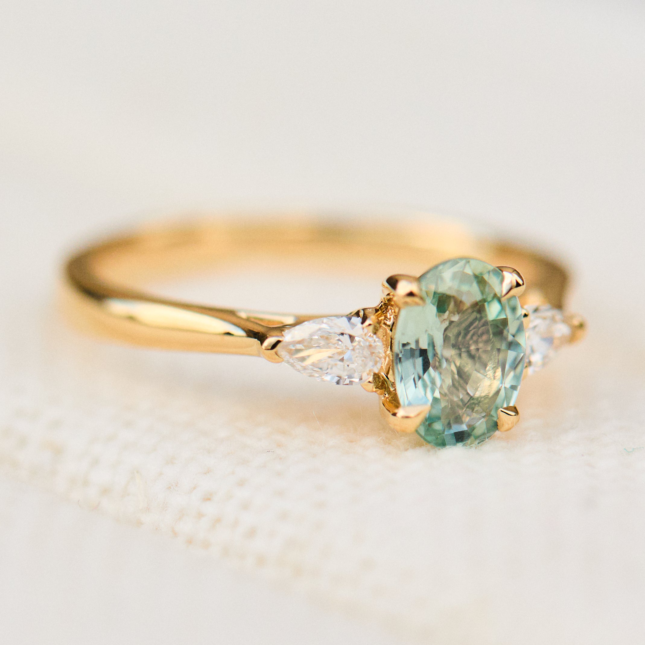 montana oval sapphire trilogy yellow gold engagement ring