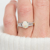 oval opal and diamond engagement ring set in yellow gold and platinum