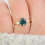 oval australian teal sapphire trilogy engagement ring in yellow gold