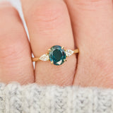 oval australian teal sapphire trilogy engagement ring in yellow gold