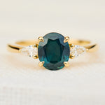 oval australian teal sapphire trilogy engagement ring in yellow gold