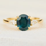 oval australian teal sapphire trilogy engagement ring in yellow gold