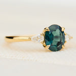 oval australian teal sapphire trilogy engagement ring in yellow gold
