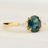 oval australian teal sapphire trilogy engagement ring in yellow gold