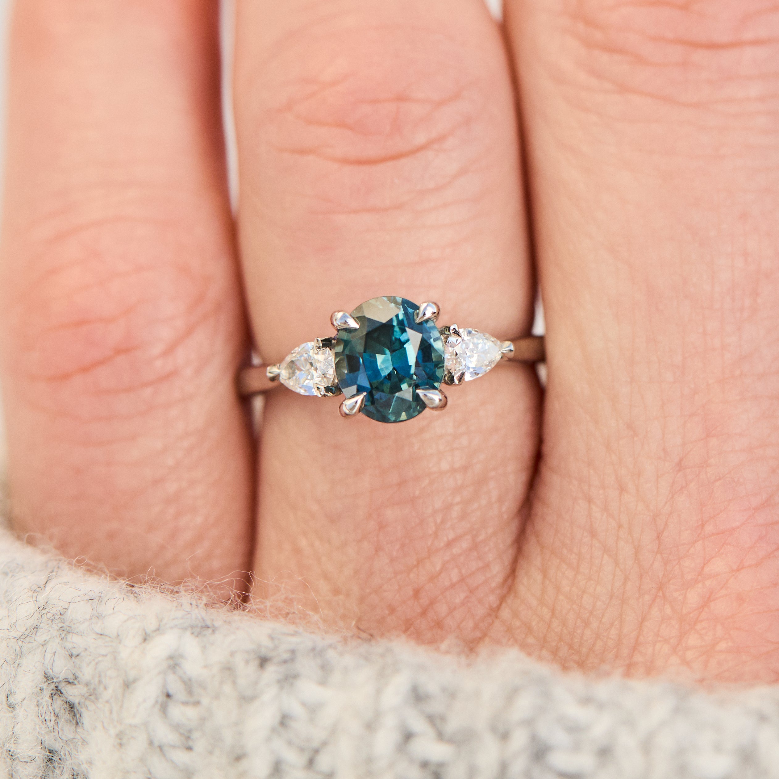 oval blue teal sapphire platinum trilogy engagement ring