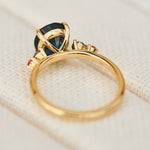 oval blue teal sapphire yellow gold engagement ring with four side stones
