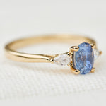 blue sapphire yellow gold trilogy engagement ring