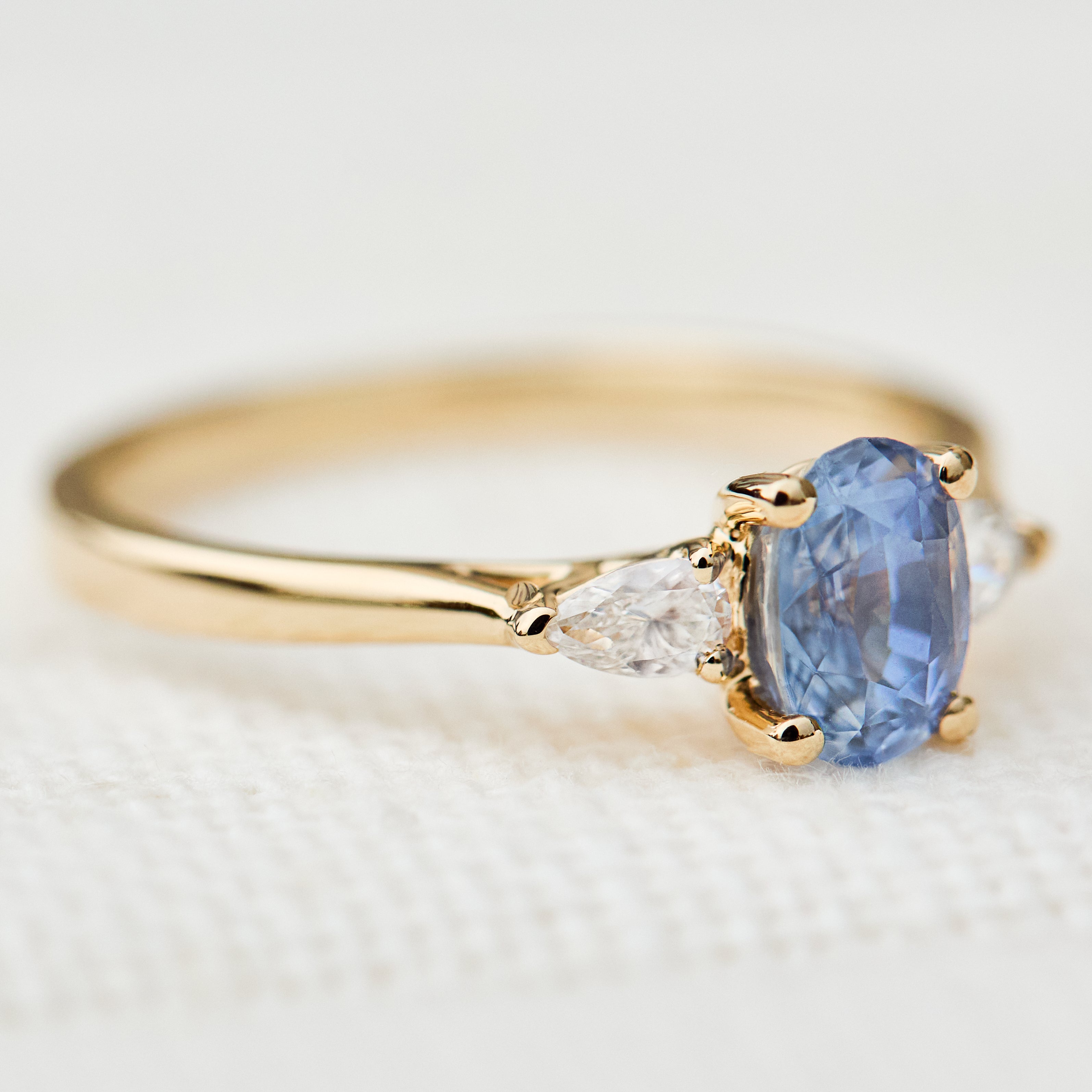 blue sapphire yellow gold trilogy engagement ring