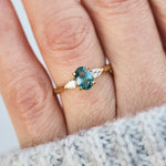 oval blue teal montana sapphire engagement ring in yellow gold