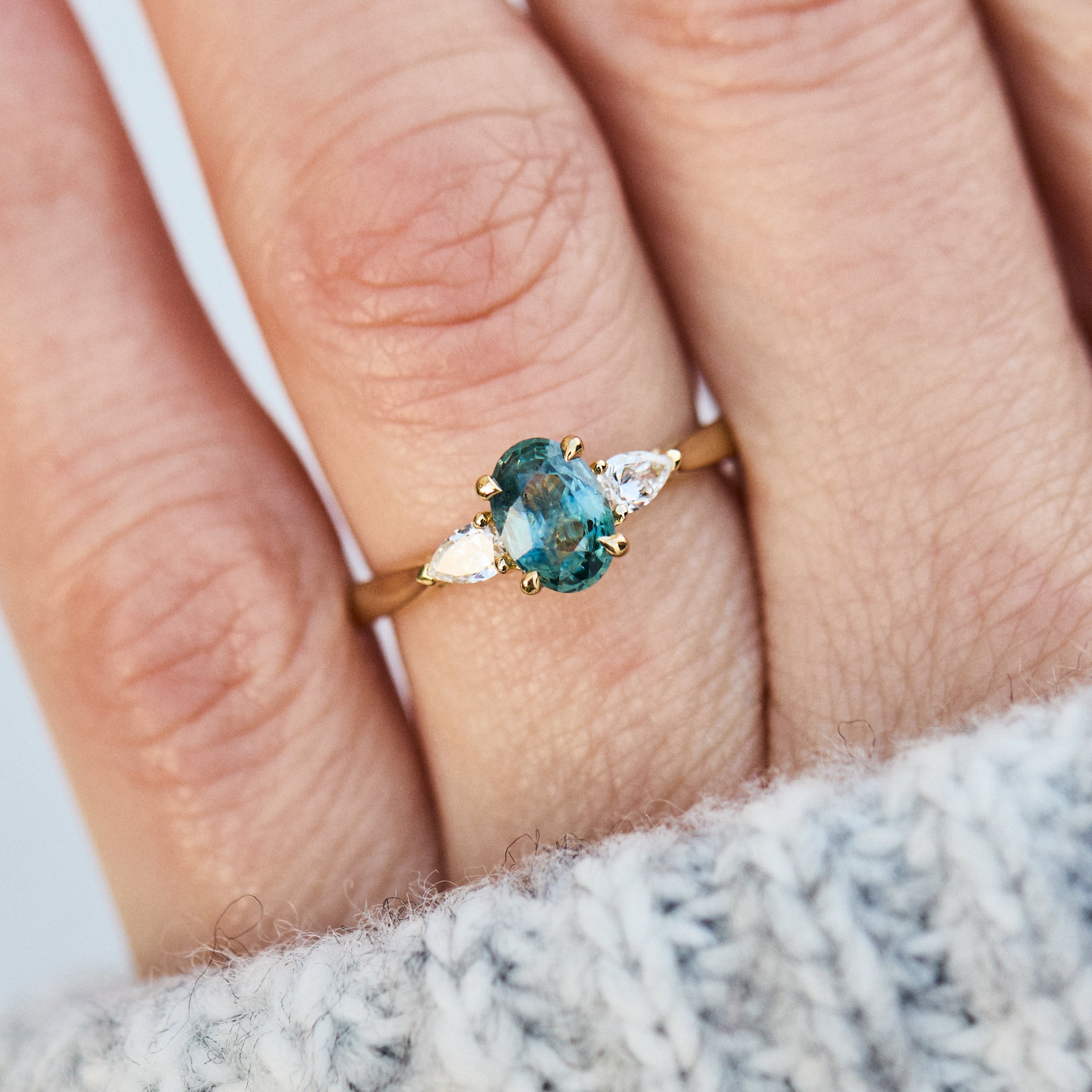 oval blue teal montana sapphire engagement ring in yellow gold