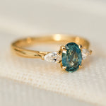 oval blue teal montana sapphire engagement ring in yellow gold
