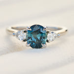 oval blue teal sapphire platinum trilogy engagement ring