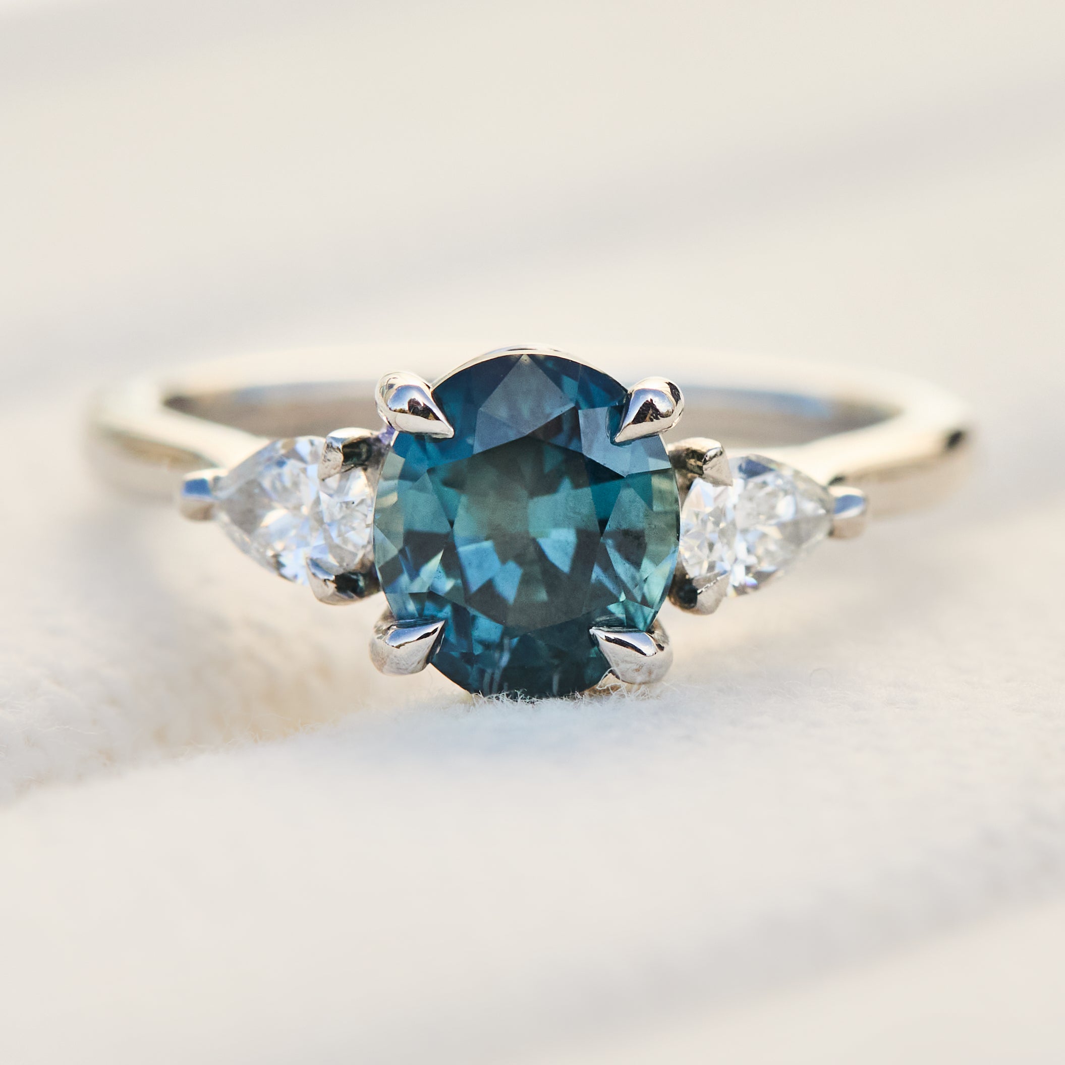 oval blue teal sapphire platinum trilogy engagement ring