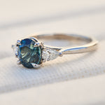 oval blue teal sapphire platinum trilogy engagement ring