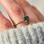 oval blue teal sapphire yellow gold engagement ring with four side stones