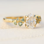 oval diamond engagement ring flanked by ten round side diamonds set in yellow gold
