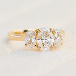 oval diamonds trilogy engagement ring set in 18ct yellow gold
