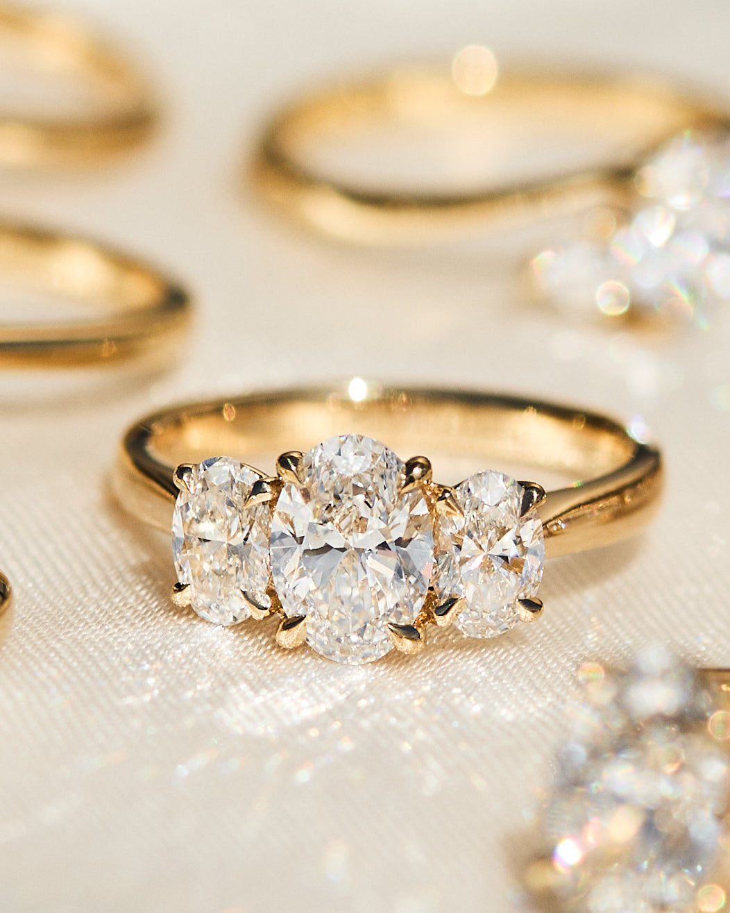 oval diamonds trilogy engagement ring set in 18ct yellow gold