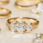 oval diamonds trilogy engagement ring set in 18ct yellow gold