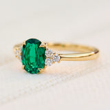 oval emerald yellow gold engagement ring with six round side diamonds