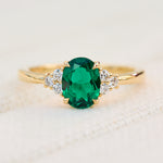 oval emerald yellow gold engagement ring with six round side diamonds
