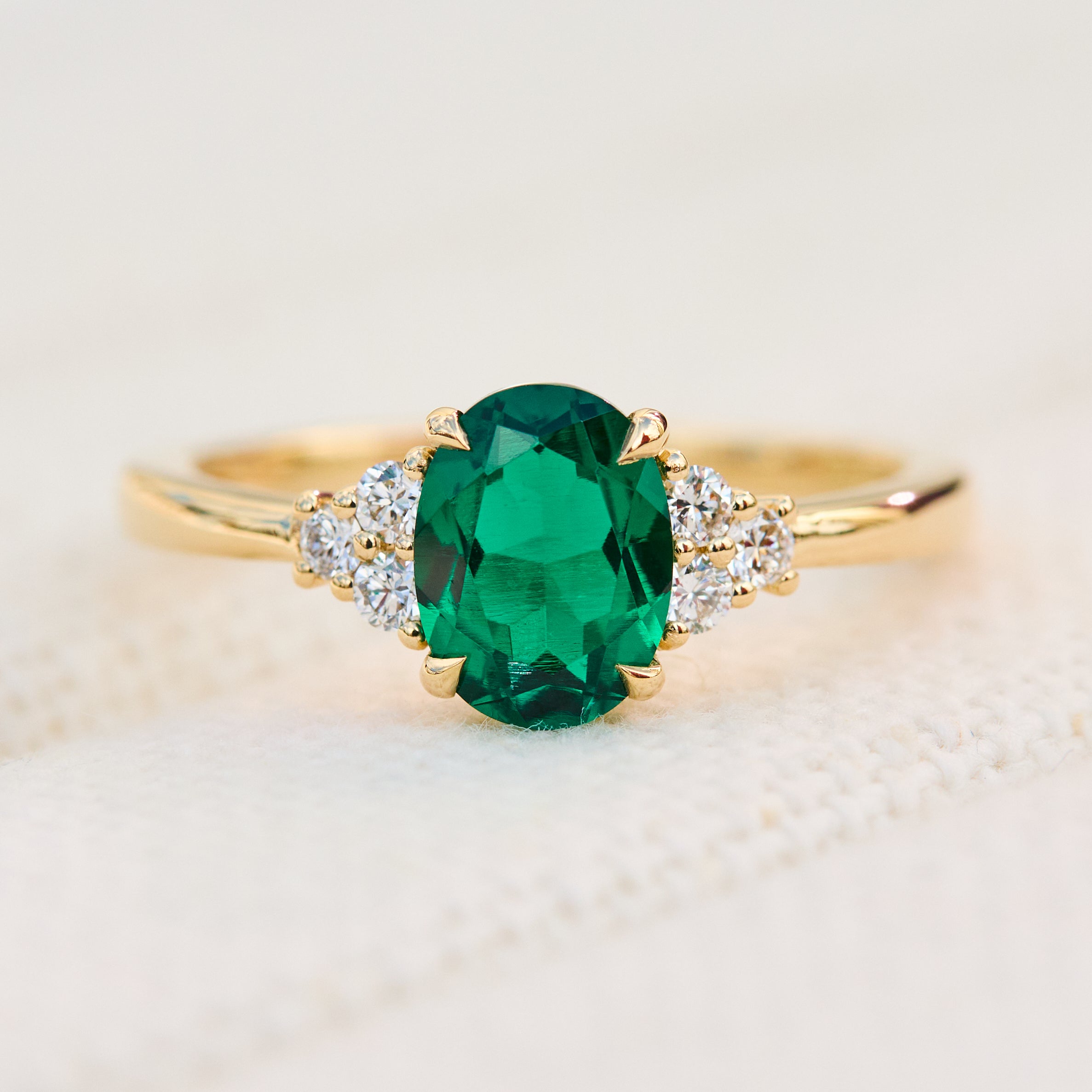 oval emerald yellow gold engagement ring with six round side diamonds