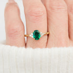 oval emerald yellow gold engagement ring with six round side diamonds