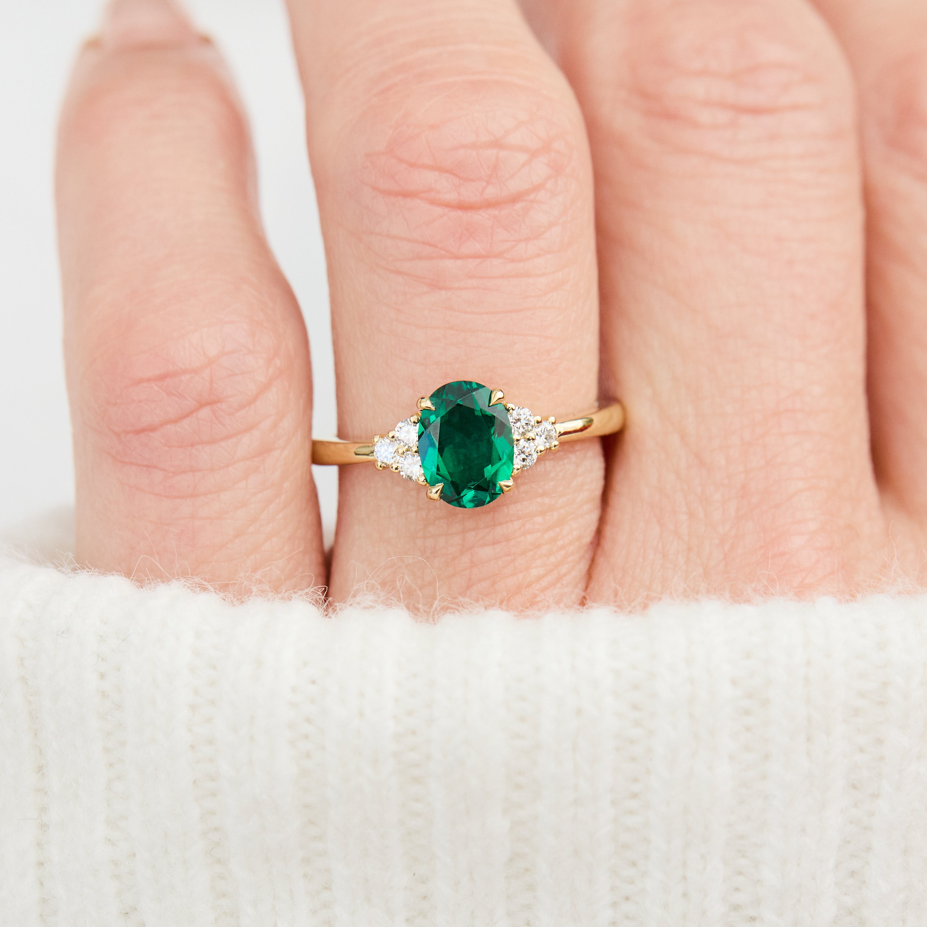 oval emerald yellow gold engagement ring with six round side diamonds