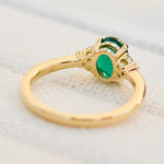 oval emerald yellow gold engagement ring with six round side diamonds