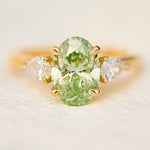 oval green lab grown diamond trilogy engagement ring in yellow gold