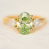 oval green lab grown diamond trilogy engagement ring in yellow gold