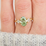 oval green lab grown diamond trilogy engagement ring in yellow gold