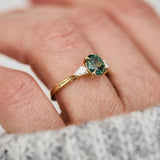 oval green teal sapphire trilogy engagement ring in yellow gold