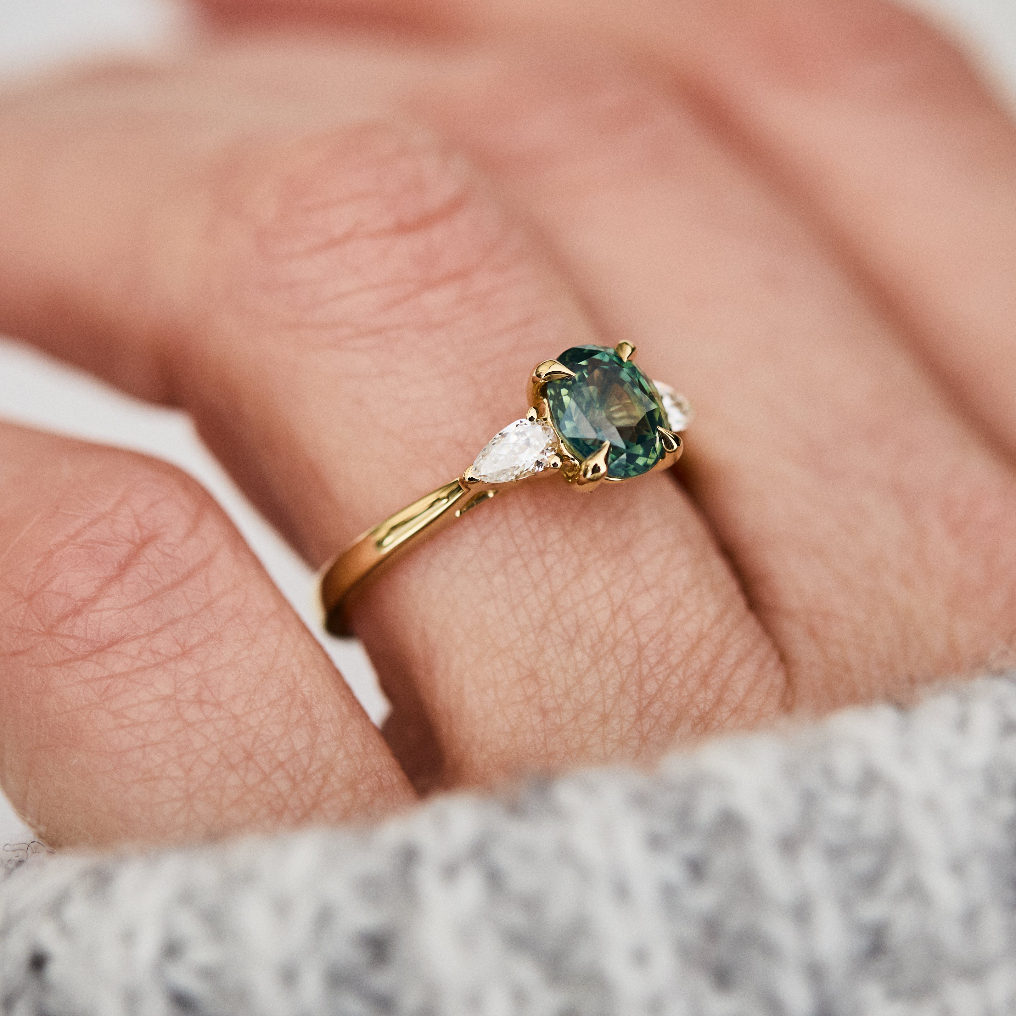 oval green teal sapphire trilogy engagement ring in yellow gold