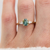 oval green teal sapphire trilogy engagement ring set in 18ct yellow gold