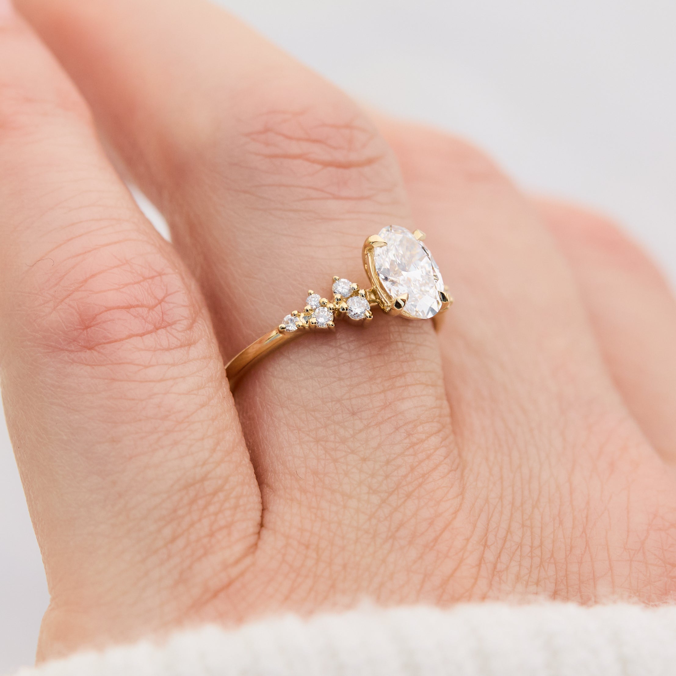oval lab grown diamond engagement ring set in timeless yellow gold