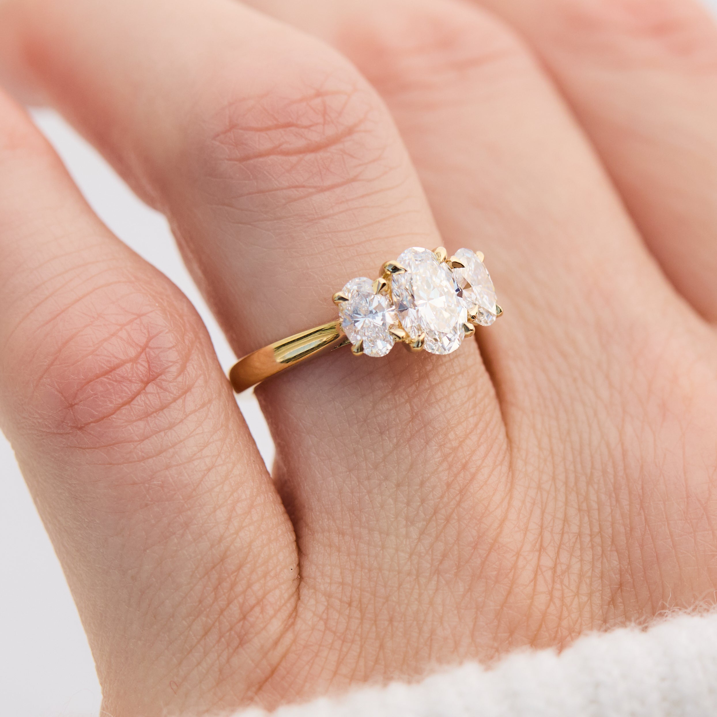 oval diamonds trilogy engagement ring set in 18ct yellow gold