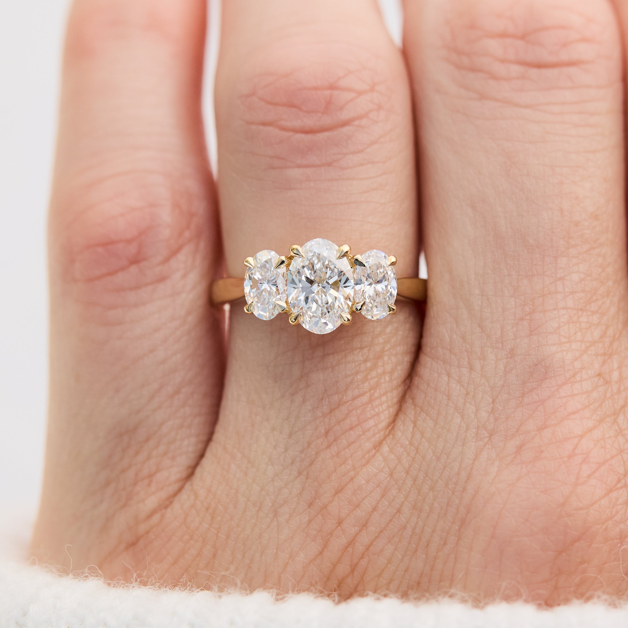 oval diamonds trilogy engagement ring set in 18ct yellow gold