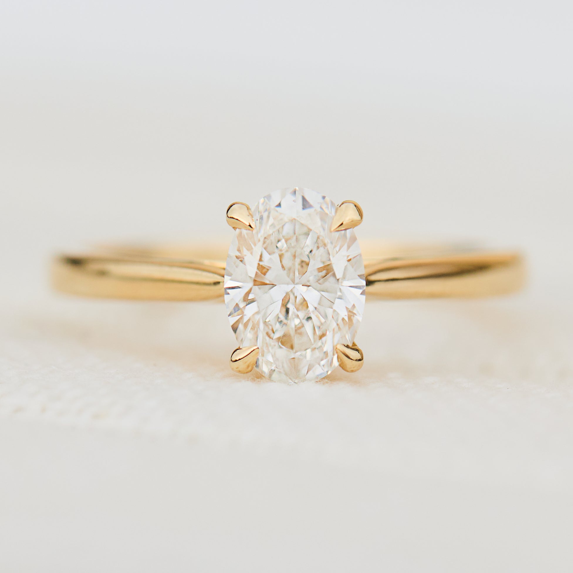 oval lab grown diamond engagement ring in yellow gold