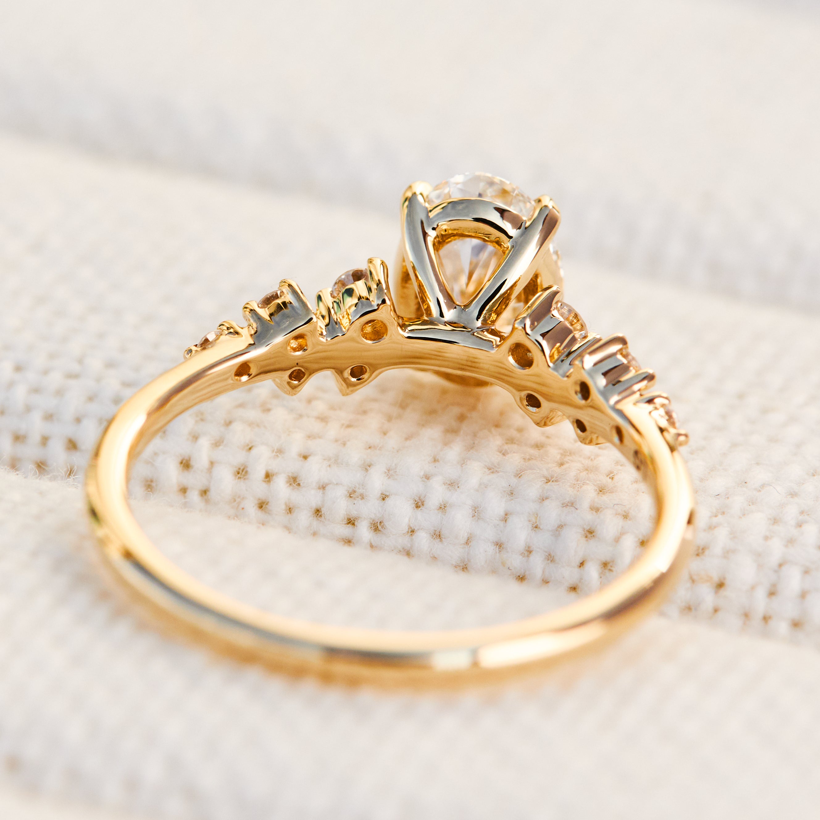 oval lab grown diamond engagement ring set in timeless yellow gold