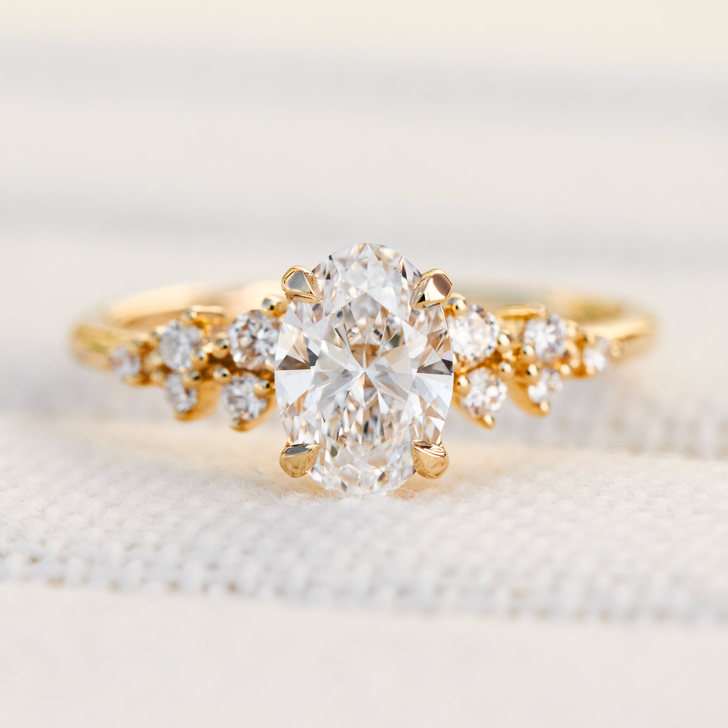 oval lab grown diamond engagement ring set in timeless yellow gold