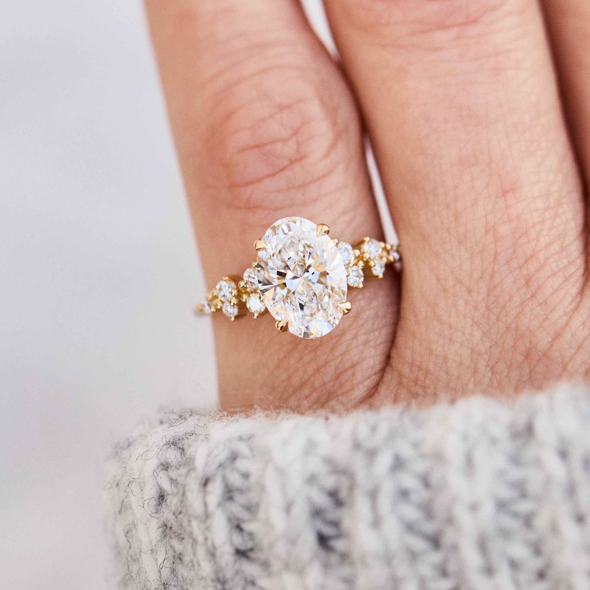 oval lab grown diamond yellow gold engagement cluster ring