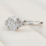 oval lab grown diamond ring in platinum paired with six round brilliant side diamonds