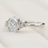 oval lab grown diamond ring in platinum paired with six round brilliant side diamonds
