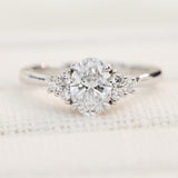 oval lab grown diamond ring in platinum paired with six round brilliant side diamonds