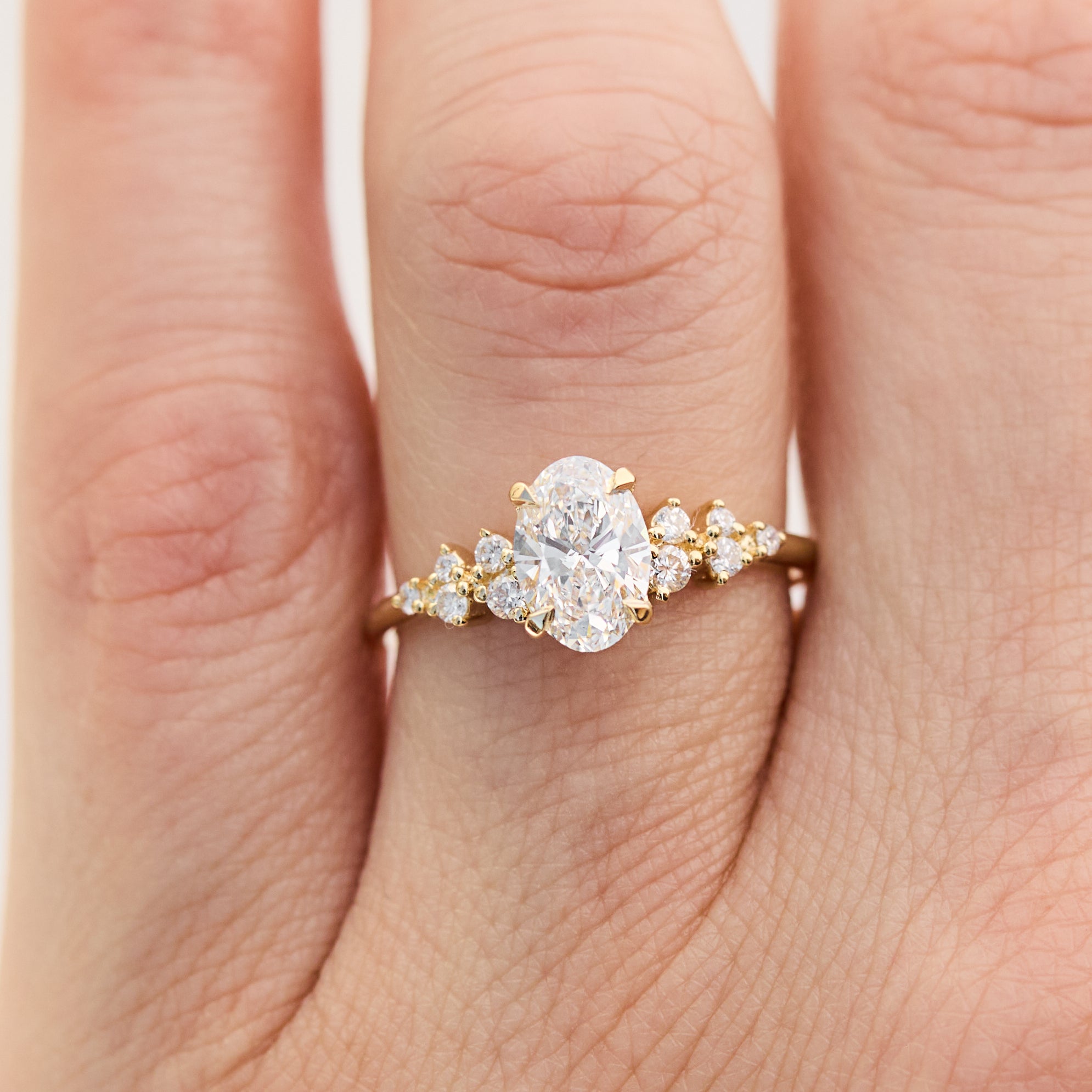 oval lab grown diamond engagement ring set in timeless yellow gold