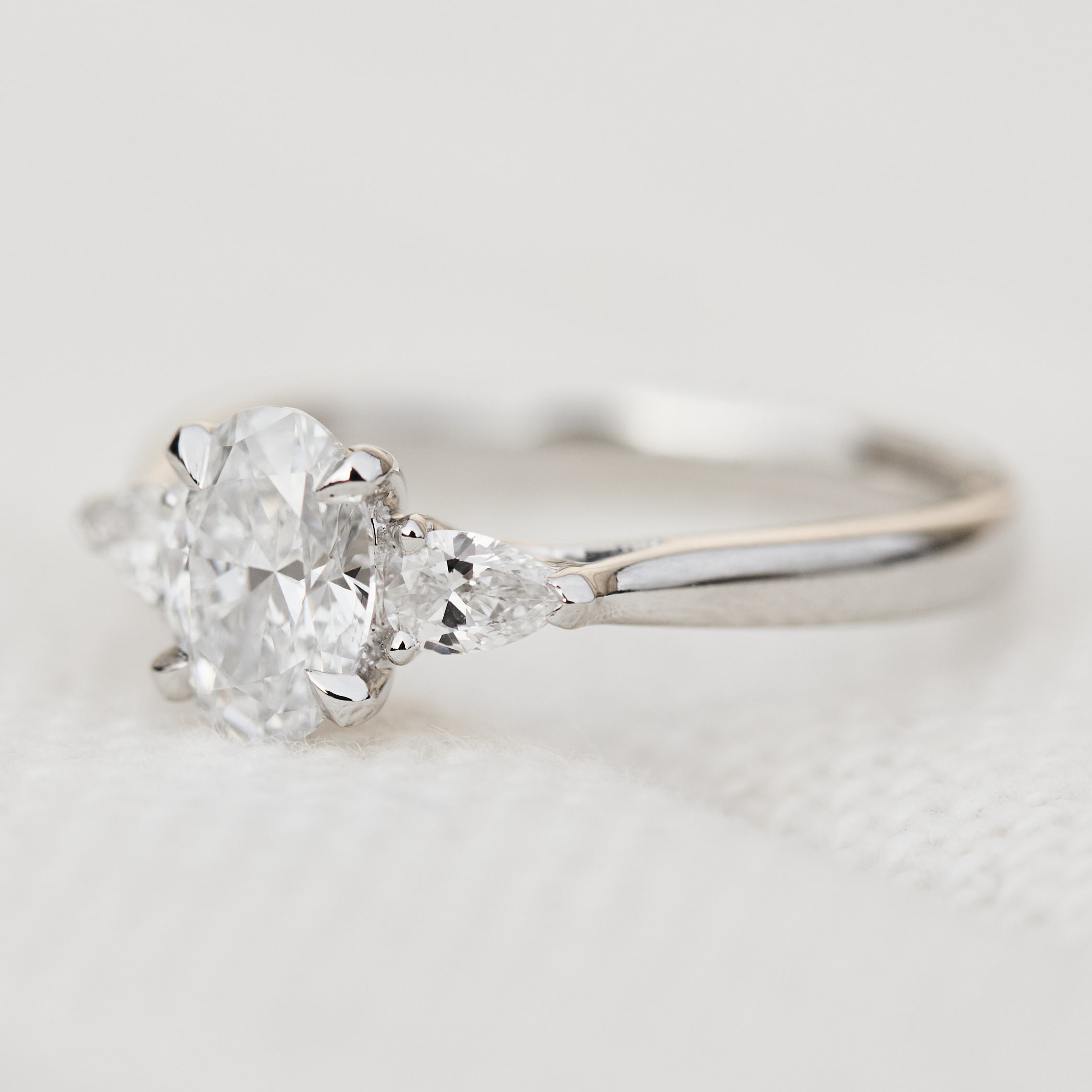 oval lab grown diamond trilogy engagement ring in platinum